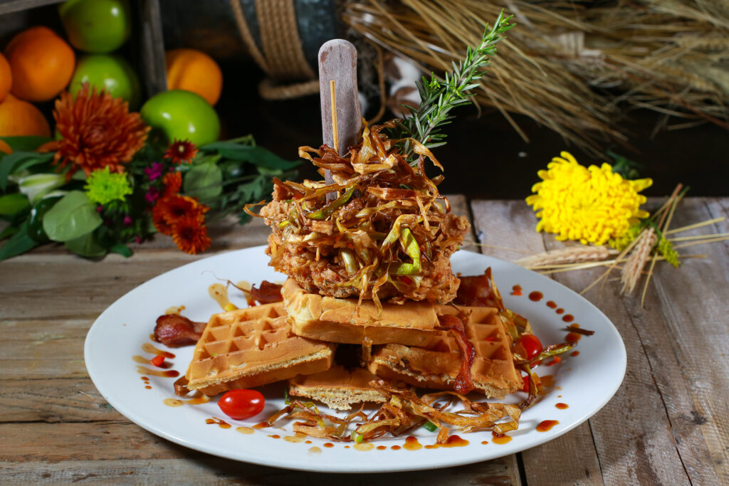 Dining Big in Las Vegas: Why Hash House A Go Go West Sahara Is the Best Spot for Bold Breakfasts and Brunch 6 Stacked chicken and waffles breakfast topped with crispy leeks and maple drizzle at Hash House A Go Go in Las Vegas