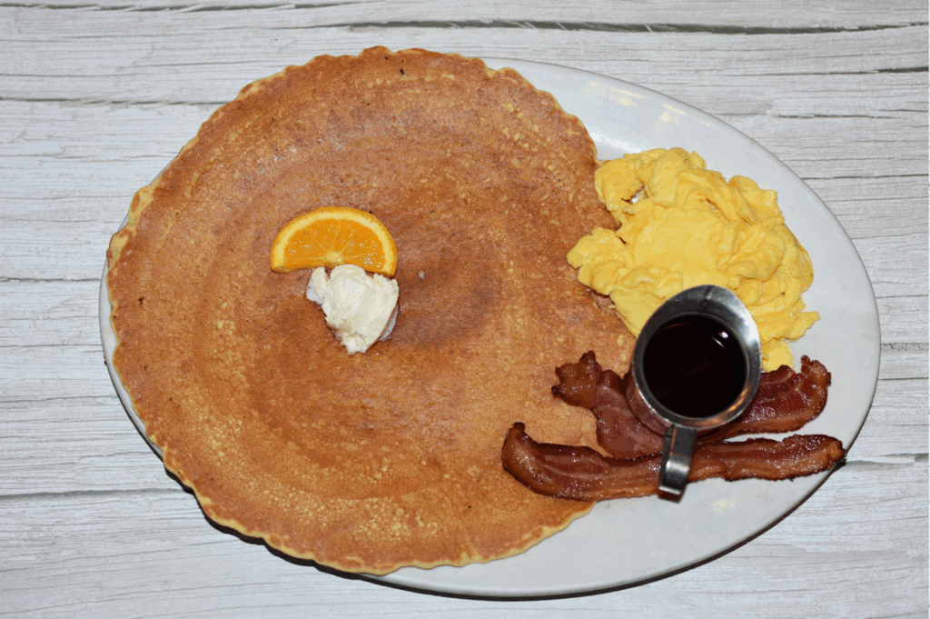 Dining Big in Las Vegas: Why Hash House A Go Go West Sahara Is the Best Spot for Bold Breakfasts and Brunch 1 Giant pancake breakfast with scrambled eggs, crispy bacon, and syrup at Hash House A Go Go in Las Vegas