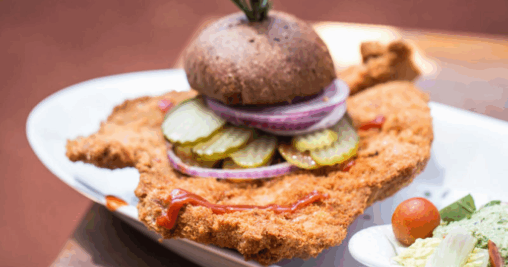 The Ultimate Guide to Comfort Food in Las Vegas at Hash House A Go Go 5 Oversized comfort pork tenderloin sandwich with pickles, onions, and rustic bun at Hash House A Go Go in Las Vegas
