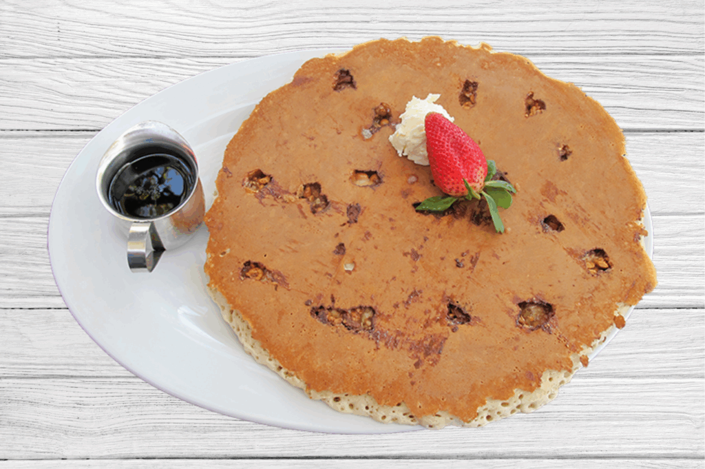 The Most Instagrammable Dishes at Hash House A Go Go: A Las Vegas Dining Experience That Shines on Social Media 1 The most indulgent Snickers pancake at Hash House A Go Go, topped with whipped butter and a fresh strawberry, served with syrup on the side—one of the most photogenic breakfast dishes in Las Vegas.