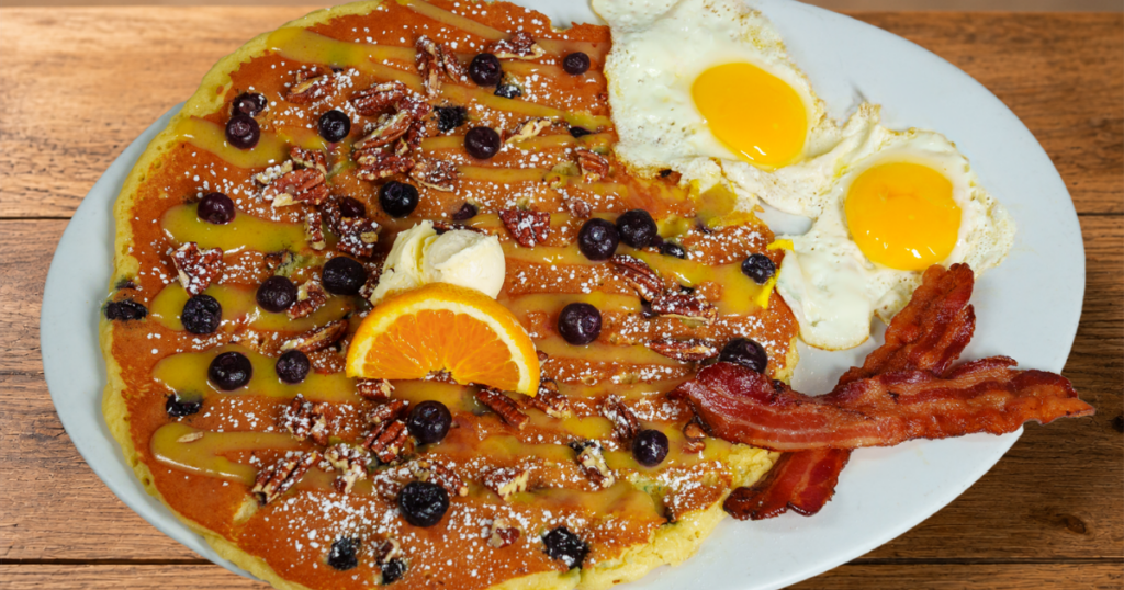 Blueberry Pecan & Lemon Glaze Flapjack with blueberries, candied pecans, eggs and bacon at Hash House A Go Go West Sahara Las Vegas